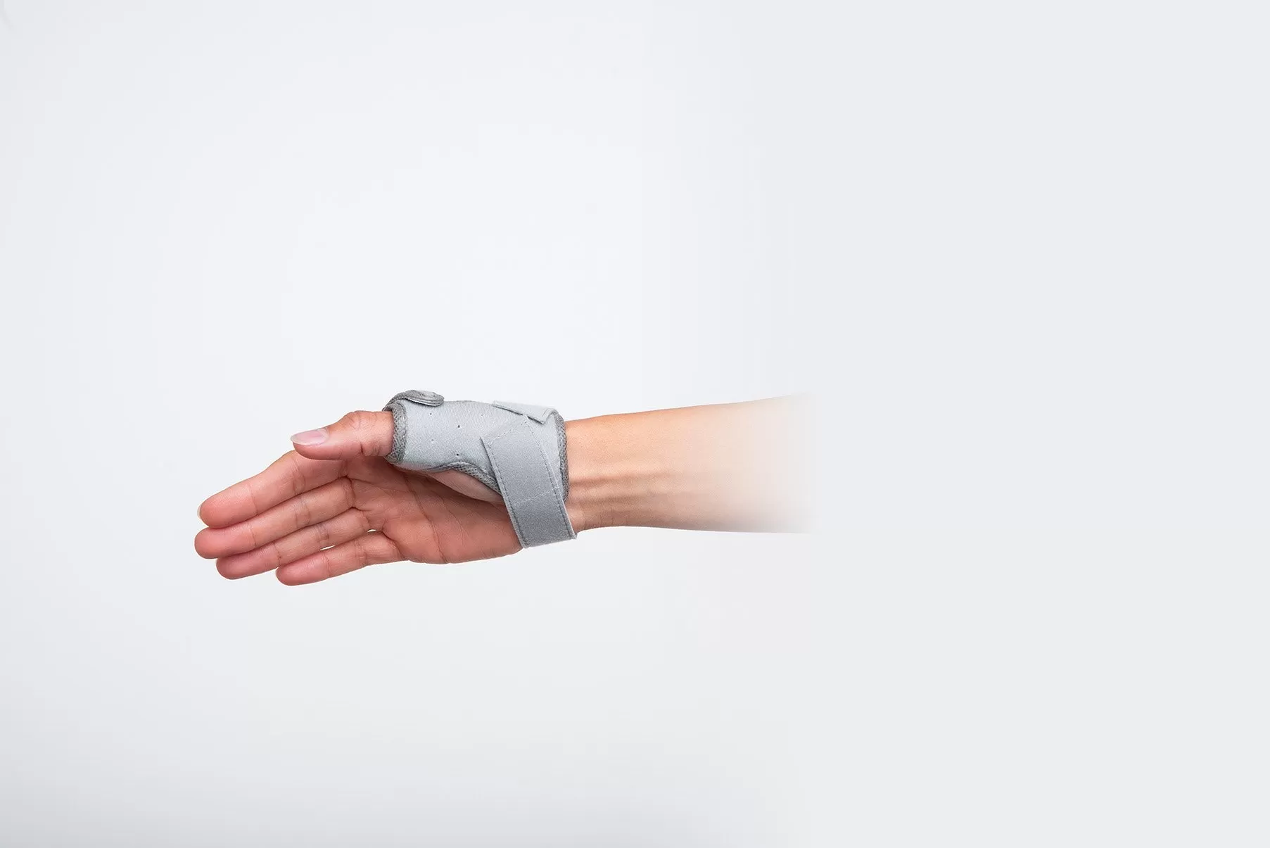 Palmar view of a thumb orthosis with an adjustable wrist strap